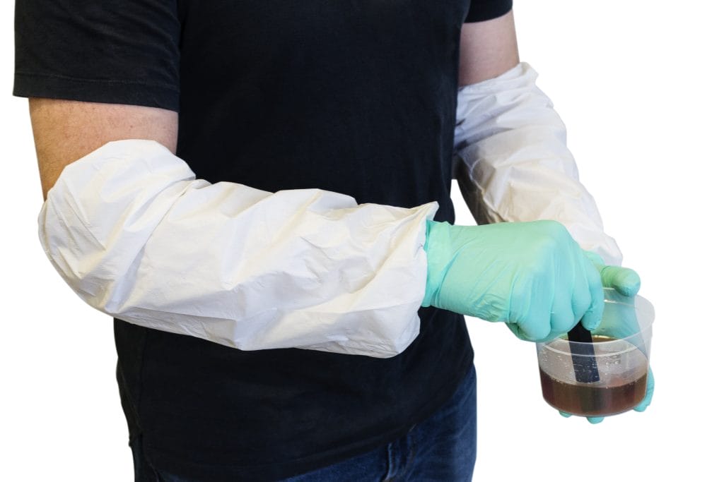 A team works with Epoxy, wearing safety masks and protective gear.